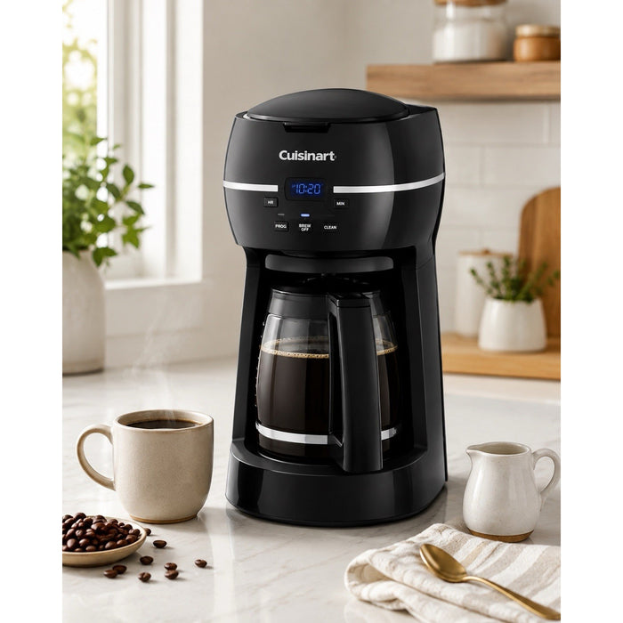Angled catalog scene of black Cuisinart DCC-1500FR coffee maker with filled glass carafe, mug, beans, cream pitcher, and spoon.