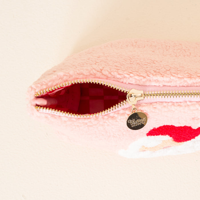 The Darling Effect's Dear Santa Teddy Pouch is a pink, textured cosmetics pouch with a gold zipper and circular pull engraved in cursive, revealing a pink checkered interiorโideal as a stylish travel accessory.