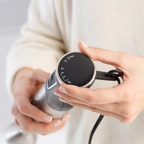 Handheld electronic device held by a person with a neutral background