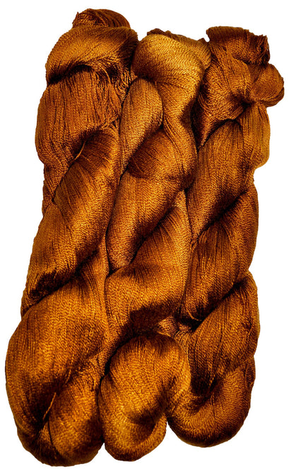 Three skeins of coppery bronze dyed 10/2 Tencel on a white background