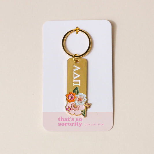 The Darling Effect’s Alpha Delta Pi Enamel Keychain features gold enamel, Greek letters, and floral designs on a “that’s so sorority collection” card—an ideal gift for any ADPi sister.