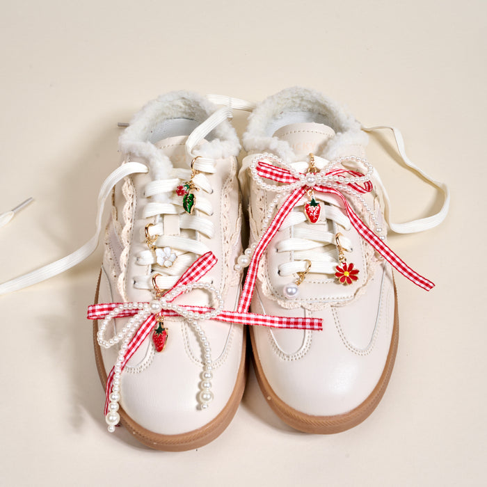 Add playful flair to your look with The Darling Effect's Berry Fresh Dazzle Shoe Charm Pack—adorable sneaker accessories featuring red gingham bows, pearl strings, and strawberry and flower charms.