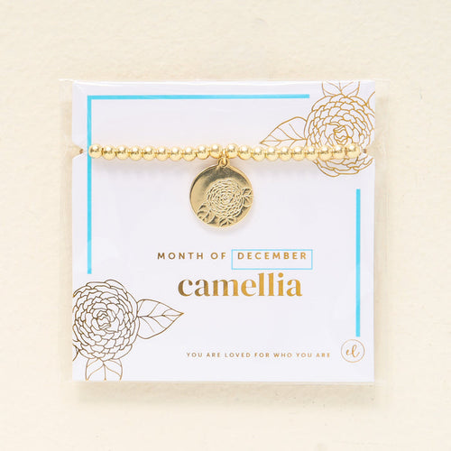 The Darling Effect Birth Flower Beaded Charm Bracelet features a gold beaded design with a December camellia charm and comes with a card: "Month of December camellia. You are loved for who you are.