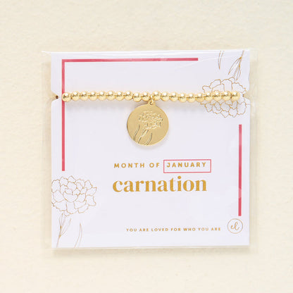 The Darling Effect Birth Flower Beaded Charm Bracelet features a gold carnation charm for January, presented on a "You are loved for who you are" card—an ideal meaningful gift.
