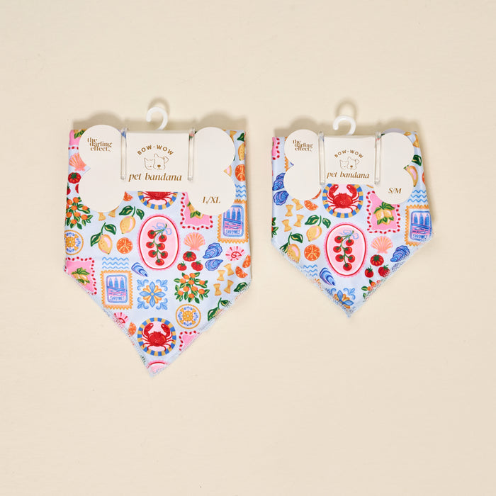 Two The Darling Effect Bow-Wow Pet Bandana-Ciao Bella accessories in L/XL and S/M, with a Mediterranean-inspired print of crabs, lemons, tomatoes, shells, and sardines on light blue—perfect for stylish pet fashion.