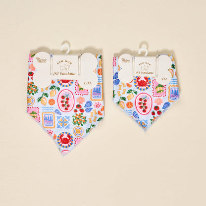 Two The Darling Effect Bow-Wow Pet Bandana-Ciao Bella accessories in L/XL and S/M, with a Mediterranean-inspired print of crabs, lemons, tomatoes, shells, and sardines on light blue—perfect for stylish pet fashion.