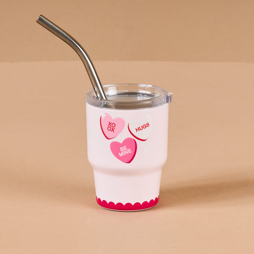 The Darling Effect’s Candy Hearts 2 oz Tiny Tumbler features a white design with pink and red heart phrases like “XO,” “Hugs,” and “Be Mine,” plus a silver metal straw—an adorable touch for your mini tumbler collection.