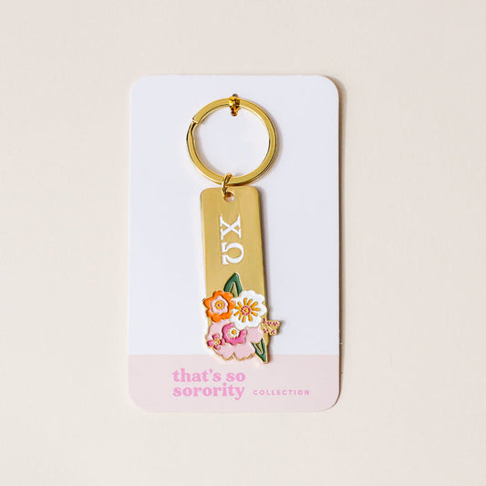 Chi Omega Enamel Keychain by The Darling Effect features ΧΩ and a floral design on a white card with “thats so sorority COLLECTION”—a stylish gift and perfect accessory for any Chi Omega sister.