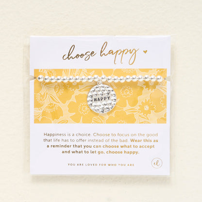 The Darling Effect Choose Happy Beaded Charm Bracelet features a silver beaded design with a round HAPPY charm, displayed on a card that reads "choose happy"—a thoughtful gift to inspire positivity.