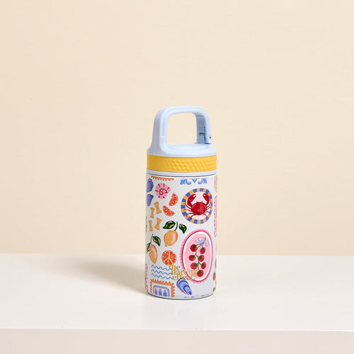 The Darling Effect’s Ciao Bella 6 oz Lil' Bitty Bottle, featuring a light blue handle, yellow lid, and bold fruit and abstract designs over beige, is the ideal stylish hydration companion for travel and adventures.