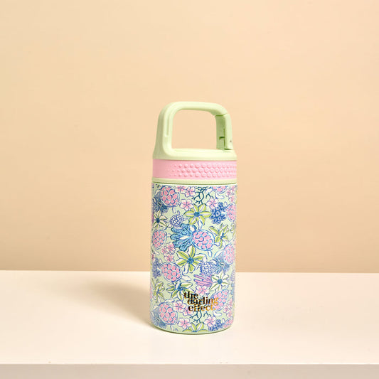 The Darling Effect’s Coastal Cove 6 oz Lil' Bitty Bottle features a light green floral design, pink accents, and a mint green handle—perfect for staying hydrated while you travel.