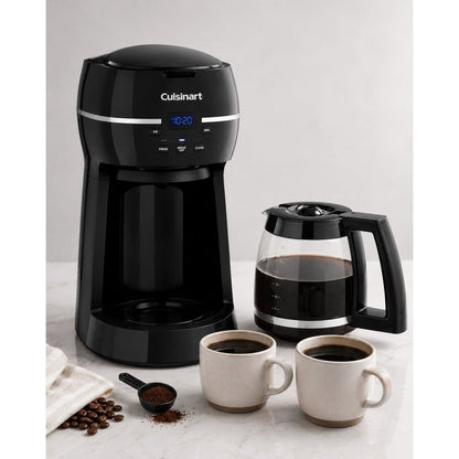 Front catalog view of black Cuisinart DCC-1500FR coffee maker beside its filled 12-cup glass carafe, two mugs, beans, and ground coffee.