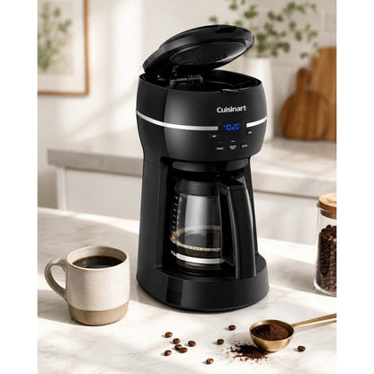 Catalog view of black Cuisinart DCC-1500FR coffee maker brewing into glass carafe with top lid open, cup, beans, and coffee scoop.
