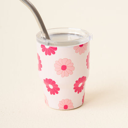 The-darling-effect's Darling Daisy Hot Pink 2 oz Tiny Tumbler features pink and red daisy patterns on white, includes a clear lid and a metal straw, and is reusable and insulated.