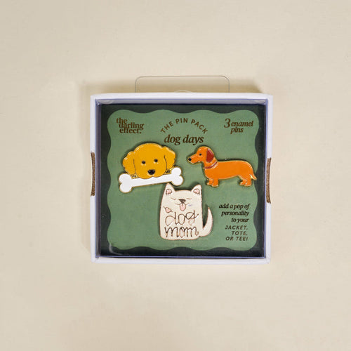 The Darling Effect Dog Days The Pin Pack includes three collectible pins—a yellow dog with a bone, a brown dachshund, and a white cat with "dog mom" text—perfect playful accessories for your jacket, tote, or tee.