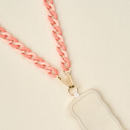A close-up of The Darling Effect’s Duo Rose Hold the Phone Crossbody Chain, a light pink chunky lanyard attached to a wavy-edged white card holder—stylish and practical for your phone on the go.