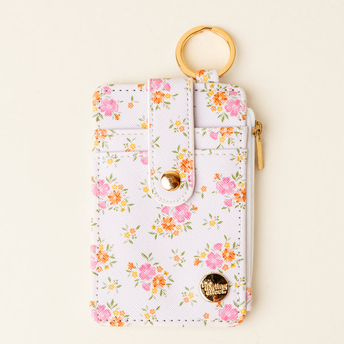 The Darling Effect’s Endless Daydream Cream Keychain Wallet features a slim, chic design with a gold keyring and zipper—perfect for keeping coins and cards secure on the go.