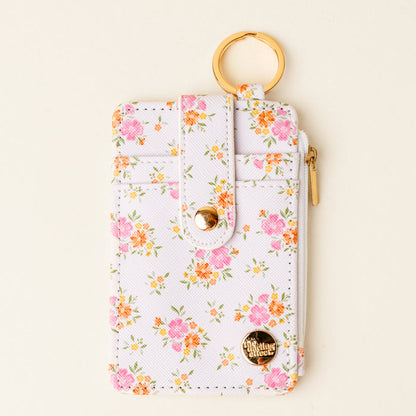 The Darling Effect’s Endless Daydream Cream Keychain Wallet features a slim, chic design with a gold keyring and zipper—perfect for keeping coins and cards secure on the go.