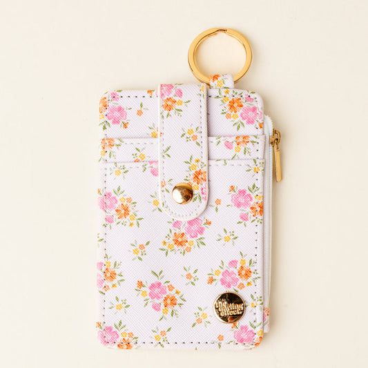 The Darling Effect’s Endless Daydream Cream Keychain Wallet features a slim, chic design with a gold keyring and zipper—perfect for keeping coins and cards secure on the go.
