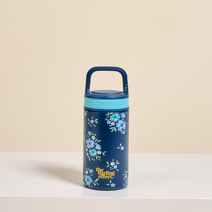 The Darling Effect Endless Daydream Navy 6 oz Lil' Bitty Bottle features a navy petite design with a light blue lid and handle, blue floral patterns, and “the darlings effect” in yellow—ideal for on-the-go hydration.