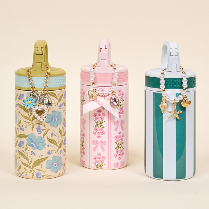 The Darling Effect's Book Shelfie 6 oz Lil' Bitty Bottle features floral designs, pink and green stripes—perfect as a stylish travel companion.