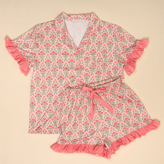 The Darling Effect's Everbloom Dusty Rose Slumber Party Pajama Shorts Set features a pink floral design, ultra-soft fabric, ruffled sleeves, and a collared button-up top with relaxed fit drawstring shorts for cozy comfort.