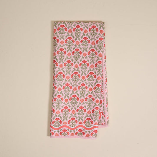 The Everbloom Dusty Rose Waffle Tea Towel by The Darling Effect features a pink and green floral pattern on white, neatly folded on a plain light surface.
