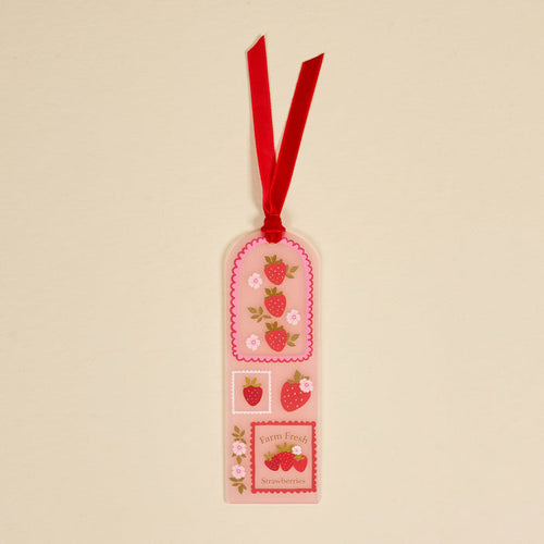 The Darling Effect's Farm Fresh Strawberries Acrylic Bookmark features strawberries, flowers, and the text "Farm Fresh Strawberries" on a cream background with a red ribbon—an adorable gift for book lovers.