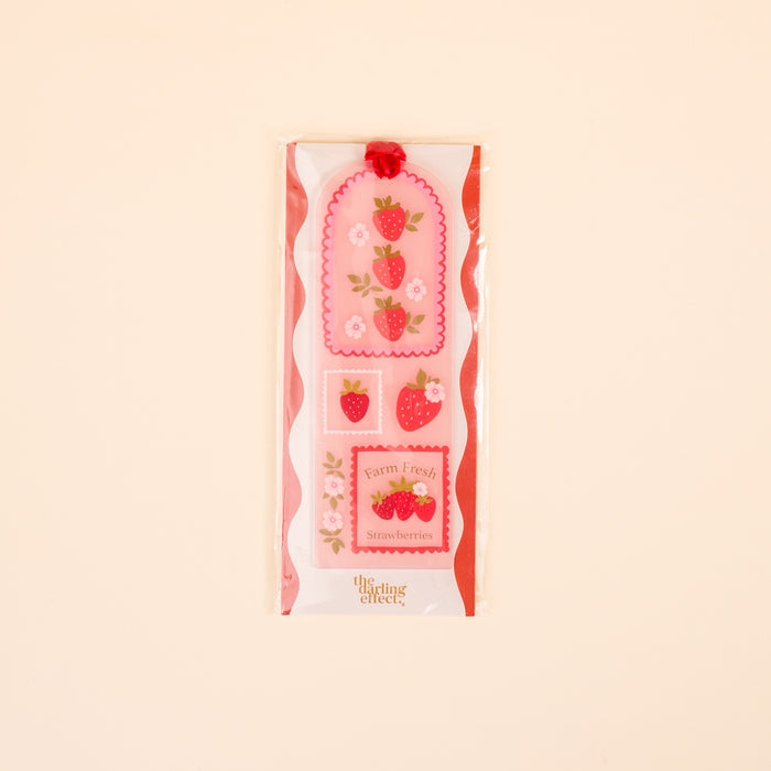 The Darling Effect’s Farm Fresh Strawberries Acrylic Bookmark makes a perfect gift for book lovers—pair with decorative stickers featuring strawberries, pink flowers, scalloped edges, and the phrases “Farm Fresh” and “Strawberries.”.