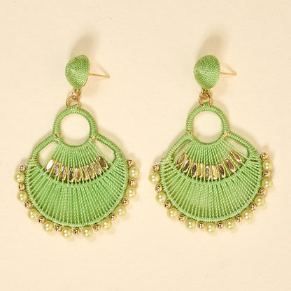 The Darling Effect’s Green Paloma Drop Earrings feature lime green, fan-shaped threads with gold and pearlescent beads. Lightweight and stylish, these earrings add a playful boho touch to any outfit—perfect for everyday wear.