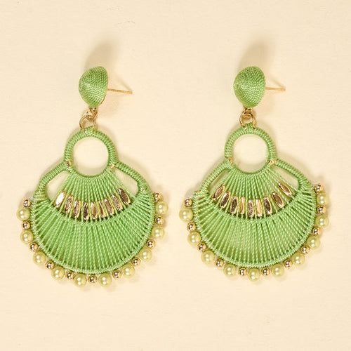 The Darling Effect’s Green Paloma Drop Earrings feature lime green, fan-shaped threads with gold and pearlescent beads. Lightweight and stylish, these earrings add a playful boho touch to any outfit—perfect for everyday wear.
