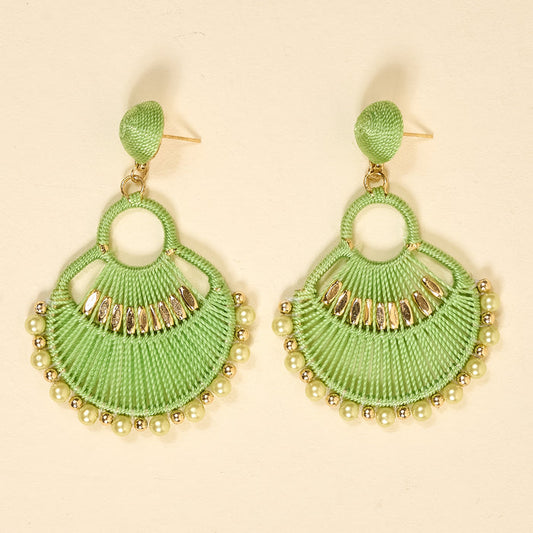 The Darling Effect’s Green Paloma Drop Earrings feature lime green, fan-shaped threads with gold and pearlescent beads. Lightweight and stylish, these earrings add a playful boho touch to any outfit—perfect for everyday wear.