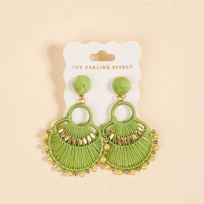 The Green Paloma Drop Earrings by The Darling Effect feature green fan shapes with gold accents and beads, perfect for daily wear, shown on a branded card against a light beige background.