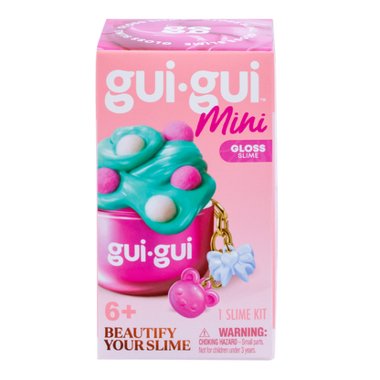 A pink box labeled Gui Gui Mini Backpack Charm Slime by Moose Toys features green and pink slime in a container with a bear keychain. Text includes "Beautify Your Slime," for ages 6+, "1 Slime Kit," and a choking hazard warning.