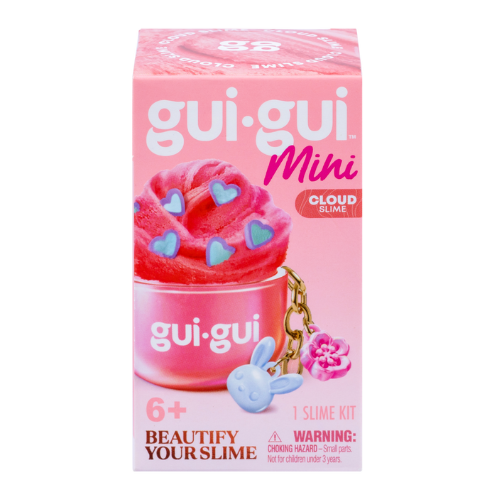 A pink box of Gui Gui Mini Backpack Charm Slime by Moose Toys, showing pink slime with blue heart sprinkles, a blue bunny charm, and a pink flower charm. For ages 6+. Includes warning label for small parts.