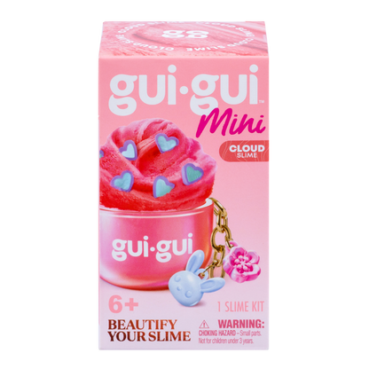 A pink box of Gui Gui Mini Backpack Charm Slime by Moose Toys, showing pink slime with blue heart sprinkles, a blue bunny charm, and a pink flower charm. For ages 6+. Includes warning label for small parts.