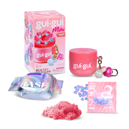 The Gui Gui Mini Backpack Charm Slime by Moose Toys features a pink container with a BASE wrapper, pink BOOST packet, keychain charms, and fluffy pink slime, all displayed beside its vibrant packaging.