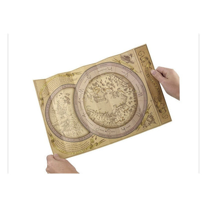 Hands holding an unfolded Hogsmeade spell map with circular illustrations and wand-movement symbols.