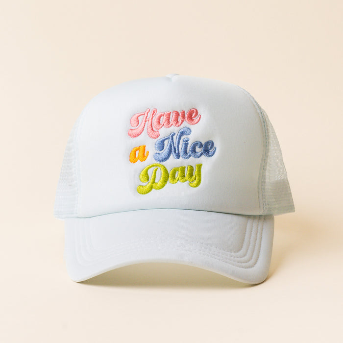 The Have a Nice Day Trucker Hat by the-darling-effect features light blue mesh and “Have a Nice Day” embroidered in pastel pink, orange, blue, and yellow—an ideal choice for trendy hat lovers.