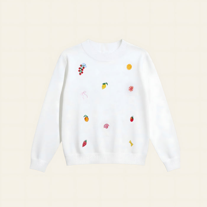 The Darling Effect’s Italian Summer Refined Knit Sweater is a white, tailored knit adorned with playful, colorful embroidered fruit—grapes, lemon slices, strawberries, oranges—and whimsical shapes for a timeless wardrobe update.