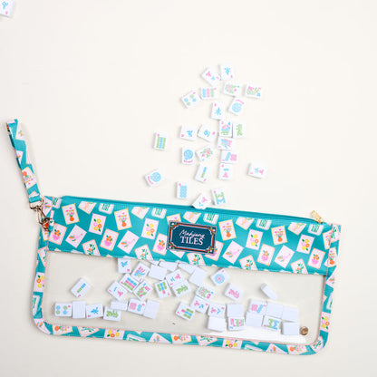 The Darling Effect’s It's Mahj Time Teal Mahjong Tile Keeper Pouch features a clear window revealing tiles inside and out, blending teal and pink style for chic tile storage.
