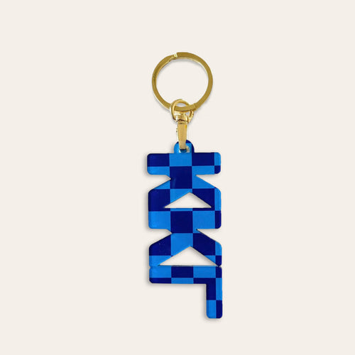 The Darling Effect's Kappa Kappa Gamma Acrylic Keychain features a gold ring and blue geometric pendant with a modern abstract design, making it a stylish sorority or bid day gift.