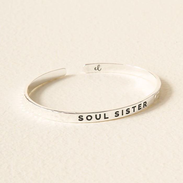 The Darling Effect’s Little Reminder Cuff features SOUL SISTER embossed outside and an el logo inside—a perfect silver bracelet to gift your cherished friend.