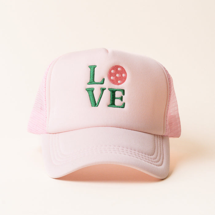 The LOVE Pickleball Trucker Hat by the-darling-effect features green embroidered "LOVE" lettering with a pink pickleball as the "O." A playful, stylish accessory for fans of trendy trucker hats.
