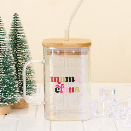 The Darling Effect’s Mama Claus Square Glass is a clear iridescent mug with a bamboo lid and glass straw, finished with “mama claus” in colorful text and small pink flowers.
