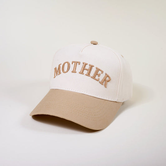 The Darling Effect’s Mother Classic Canvas Hat features a cream canvas with a tan brim and "MOTHER" embroidered in tan cursive on the front. Its relaxed fit offers effortless, casual style.