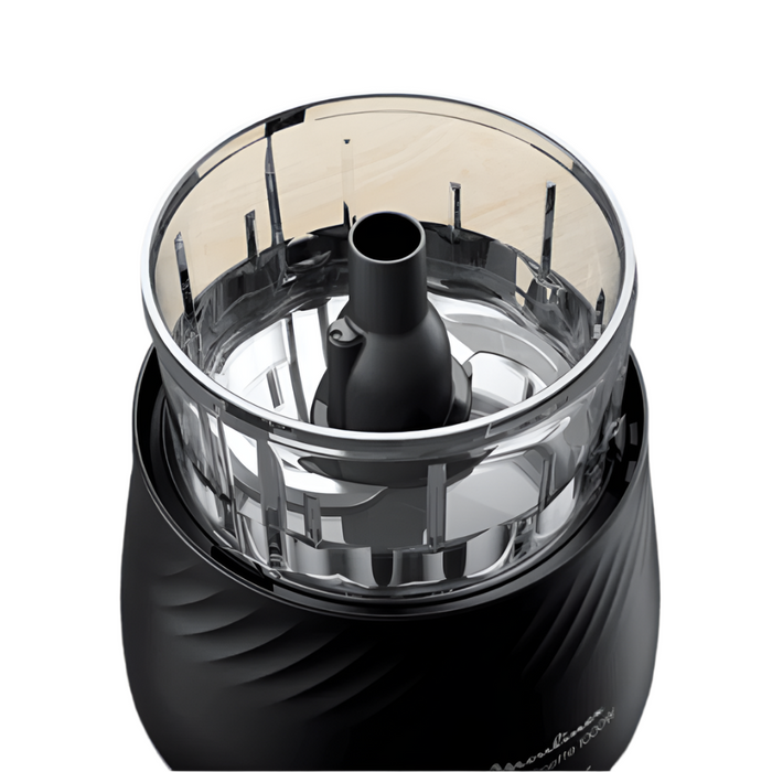 Black and silver kitchen grinder on a wooden surface