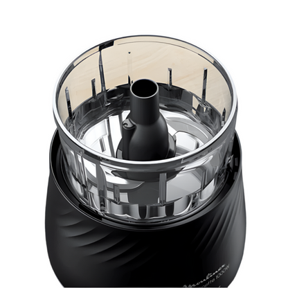 Black and silver kitchen grinder on a wooden surface