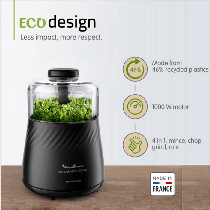 Black food processor with green herbs, 'Eco design' text, and features on a white background
