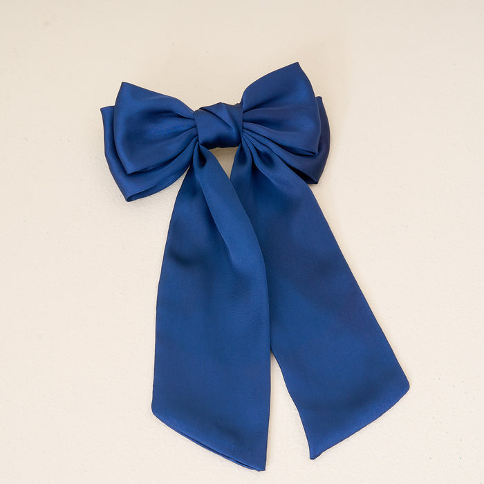 Add elegance to your look with The Darling Effect Navy Satin Hair Bow, featuring a shiny finish and two long trailing ribbons—perfect for any hair accessories collection.